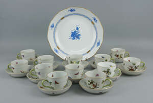 A collection of twelve Herend Rothschild pattern coffee cups and saucers, 20th century, decorated with birds and flowers, together with a Herend dish decorated