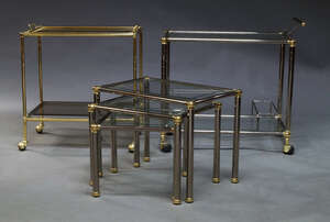 
	
		A chromed and brass tea trolley, late 20th Century, with two glazed tiers, raised on...