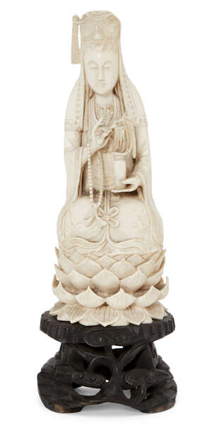
	
		A Chinese Canton ivory figure of Guanyin, late 19th century, seated on a lotus throne...