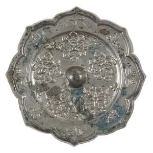 A Chinese silvered bronze octafoil mirror of lighua type, Tang dynasty, finely cast with five floral motifs around the central raised knob inside a border of b