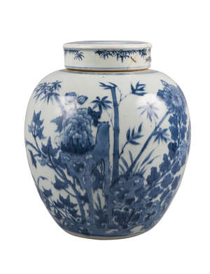 A Chinese porcelain jar and cover, 18th century, painted in underglaze blue with chrysanthemum and bamboo issuing from a rocky outcrop, underglaze blue double 