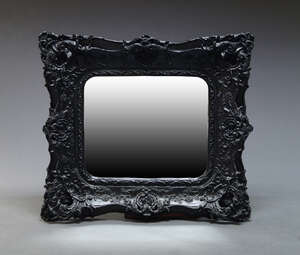 
	
		A black resin continental style wall mirror, of recent manufacture, with overall...