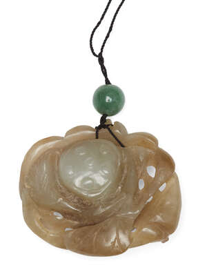 
	
		A Chinese celadon jade lotus pendant, early 20th century, carved to both sides with a...