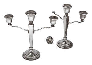 A pair of silver three-branch candlesticks, Birmingham, c.1959, F. H. Adams & Holman, the squared tapering stems to stepped circular feet, each branch to an ur