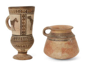 A buff pottery single-handled vessel, North West Iran, 2nd Millenium B.C., the sides slightly flaring towards the convex base, a looped handle linking the ever