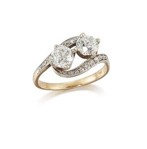 
	
		An Edwardian, diamond two stone ring, of crossover design, each diamond weighing...