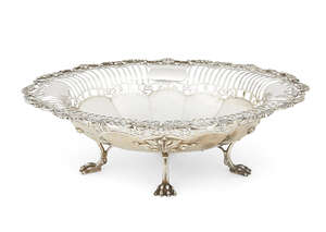 
	
		A pierced silver dish, Sheffield, c.1913, Mappin & Webb, raised on four lion paw feet,...