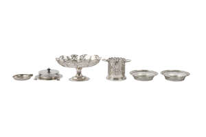A silver pedestal bowl, Sheffield c.1923, of oval form, with pierced scallop shape border, 13.5cm high x 27.2cm wide, also a silver twin handled bottle stand, 