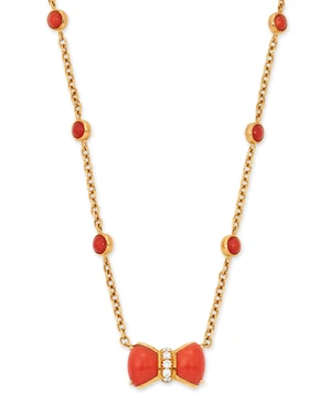 A coral necklace, the bow-form pendant set with carved coral cabochons and central line of...