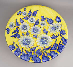 
	
		A large Italian tin glazed earthenware circular charger, of recent design by Ceramiche...