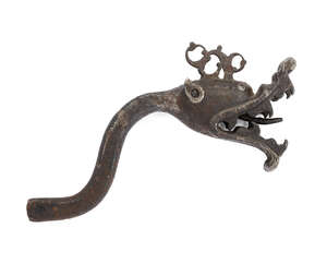 
	
		A Safavid iron dragon head metal fixing, Iran, 16th century, with curved attachment...
