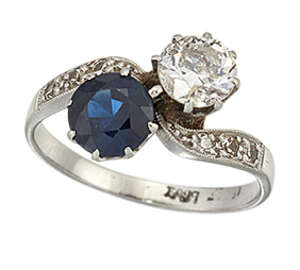 
	
		A diamond and sapphire two stone ring, of crossover design set with a single...