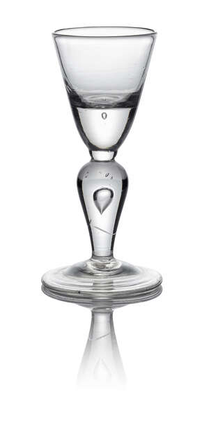A Queen Anne heavy baluster wine glass, c. 1710, with heavy based round funnel bowl above large teared inverted baluster knop, on circular foot, 15cm high