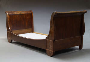 
	
		A French mahogany lit en bateau, late 19th Century, the scrolling ends with gilt metal...