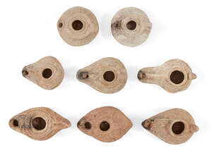 Eight Syrian-Palestinian pottery oil lamps, Circa 5th-7th Century A.D, Six with extended...