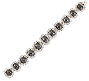 
	
		A coloured diamond and rose-cut diamond bracelet, composed of a line of graduated oval...