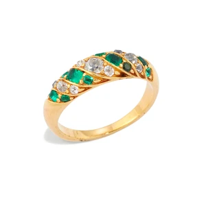A gold emerald and diamond ring, with alternating rows of old-cut emeralds and diamonds,...