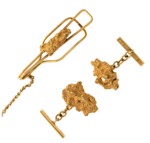 
	
		A pair of cufflinks and a tie slide, the cufflinks each composed of a nugget to baton...