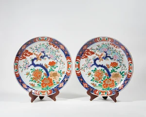 A pair of Japanese porcelain chargers, 20th century, impressed seals and inscribed kanji in iron...