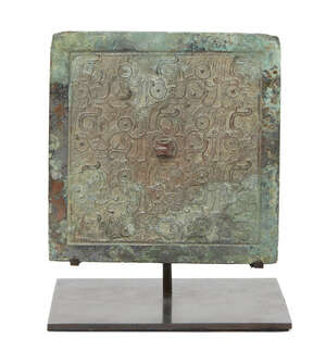 A Chinese bronze square mirror, Eastern Zhou/Warring States period, 5th/4th century BCE, finely cast with overlapping stylised bird motifs around a central rai