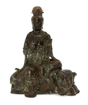 
	
		A Chinese bronze figure of Guanyin atop and elephant, late Qing dynasty, Guanyin modelled...