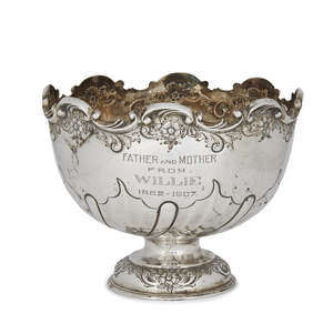 A silver presentation bowl, Sheffield, c.1905, Levesley Brothers, the half-lobed twist repousse bowl raised on a single circular foot to body engraved with the