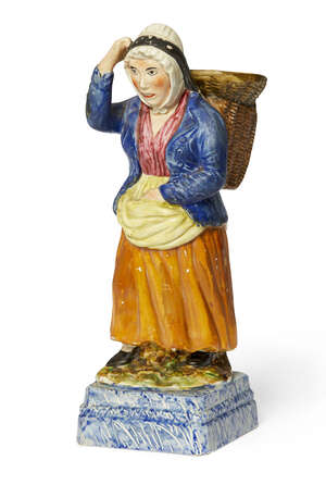 
	
		A Portobello pottery figure of a fisher woman, Rathbones period circa 1830, modelled with...