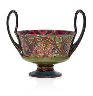
	
		William Moorcroft (1872-1945), a twin-handled ceramic bowl with red lustre     
		
