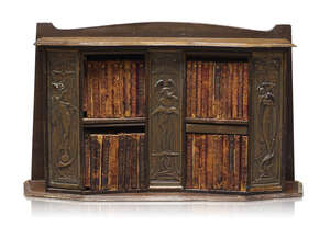 A small Arts & Crafts stained pine Book case with Forty works by William Shakespeare
		c.1897
		The oak frame and shelves set with three brass figurative pan