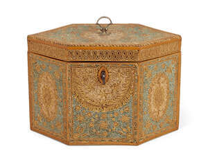 
	
		A George III paperscroll hexagonal tea caddy, silver loop handle above single lidded...