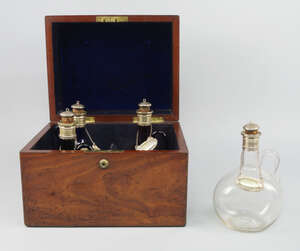 
	
		A Georgian mahogany four bottle tantalus, with a Bramah's lock, with four coloured glass...