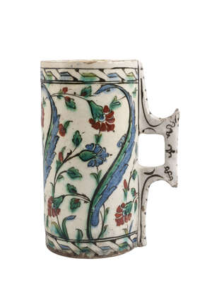 
	
		An Iznik polychrome pottery tankard, Turkey, circa 1585-95AD,  of cylindrical form with a...