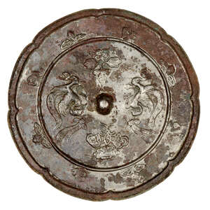 
	
		A Chinese bronze lobed mirror, Tang dynasty, the central knob surrounded by the phoenixes...