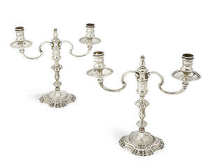 A pair of George II style two branch silver candelabra, 1961/62, J B Chatterley & Sons Ltd., with scrolled arms and knopped pillars above shaped square bases, 