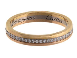 
	
		Two diamond band rings, by Cartier and Tiffany & Co, each set with a line of...