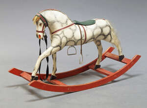 
	
		A Child's miniature carved and painted wood rocking horse, early 20th century, with green...