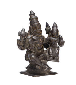 A South Indian bronze figure of Vishnu and Lakshmi, 18th century, on a square base, Vishnu shown seated with Lakshmi on his lap, wearing elaborate bracelets an