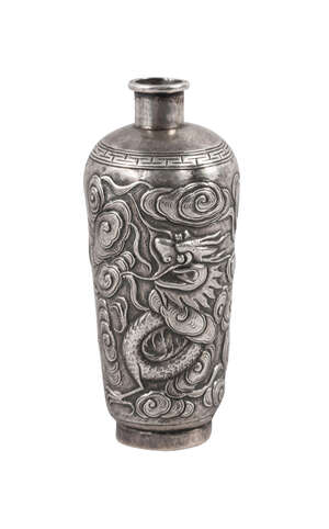 
	
		A Chinese silver snuff bottle, late 19th century, repousse decorated with a dragon amid...