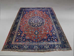 
	
		A Tabriz carpet, mid 20th Century, with blue pole medallion in foliate decorated red...