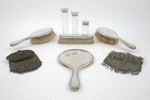 
	
		A seven-piece silver dressing table set, London, c.1912, Charles Fox & Co., comprising a...