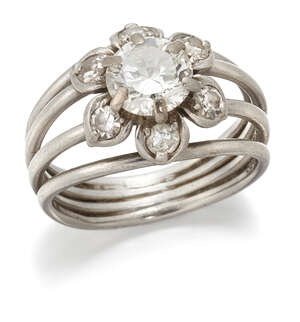 
	
		A diamond flower head cluster ring. composed of a central claw-set brilliant-cut  diamond...