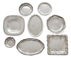 
	
		A group of German silver dishes and small trays, comprising: a square dish with gadroon...