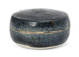 A Chinese blue-glazed pottery cosmetic box, Tang dynasty, of circular form, covered in a slightly mottled blue glaze, the base and interior unglazed, 7cm diame
