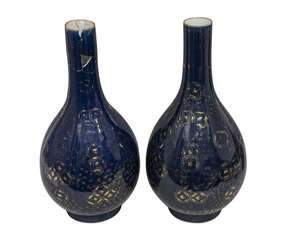 A pair of large Chinese porcelain powder-blue bottle vases, 18th century, gilt painted with cash symbols on a cracked ice ground, 60cm high