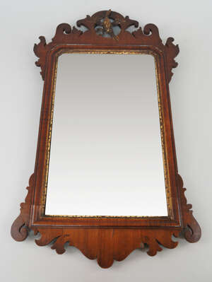 
	
		A George III  style fret carved mahogany mirror, with pierced bird cresting flanked by...