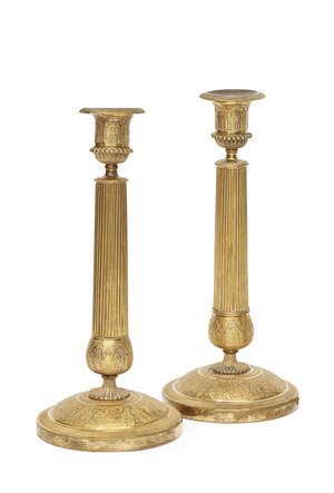 
	
		A pair of French gilt bronze Empire style candlesticks, mid 19th century,  the nozzles of...