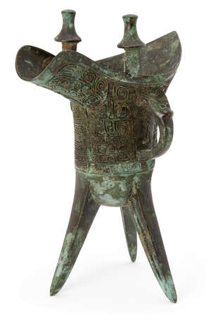 A Chinese archaic bronze ritual wine vessel, jue, Shang dynasty-style, the deep U-shaped body...