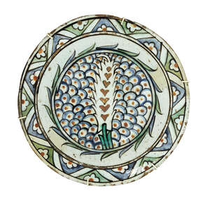 
	
		An Iznik pottery dish, Turkey, 17th century, of shallow rounded form on a short foot with...