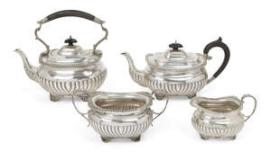 
	
		A matched silver four-piece tea service, the teapot and tea kettle Birmingham, c.1910, SW...