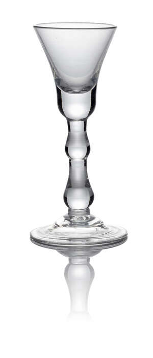 A George II balustroid wine glass, c. 1750, with heavy based bell bowl above a medial drop and basal true baluster knop, on circular foot, 14cm high